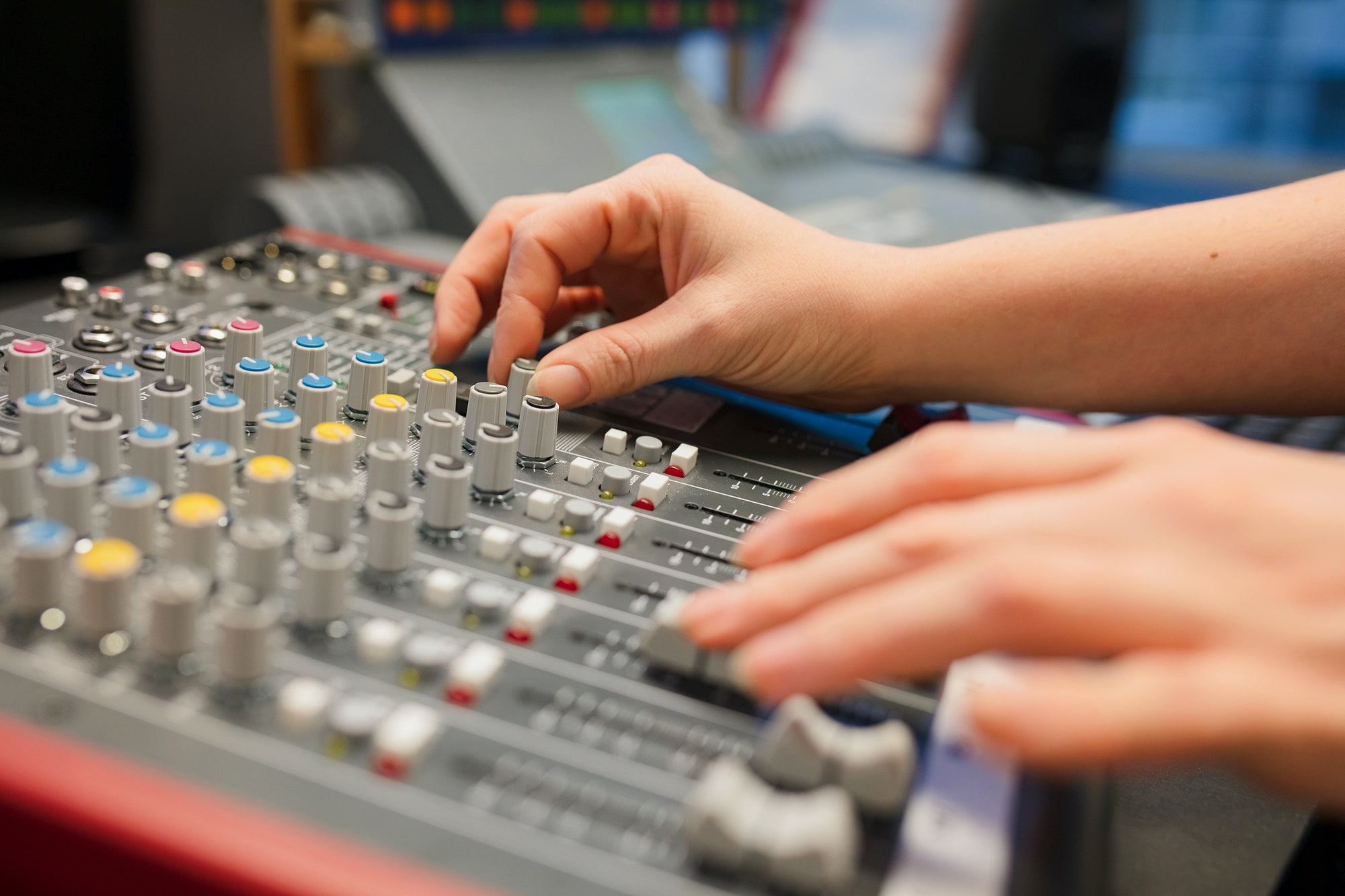 Female Radio Host Using Music Mixer In Studio